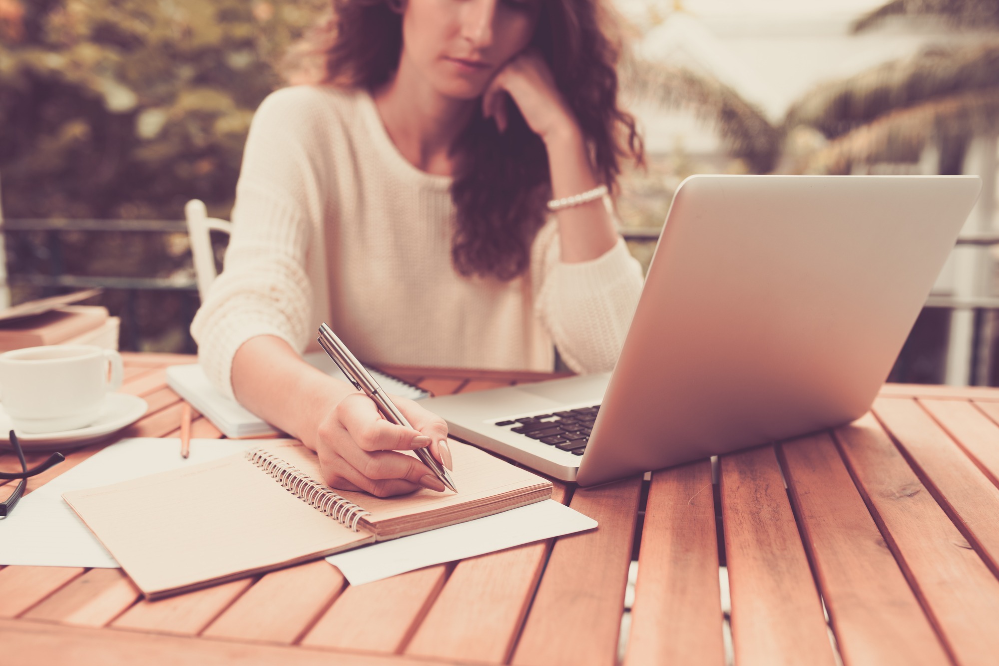 Woman Working On Computer and Writing Down Her Thoughts.